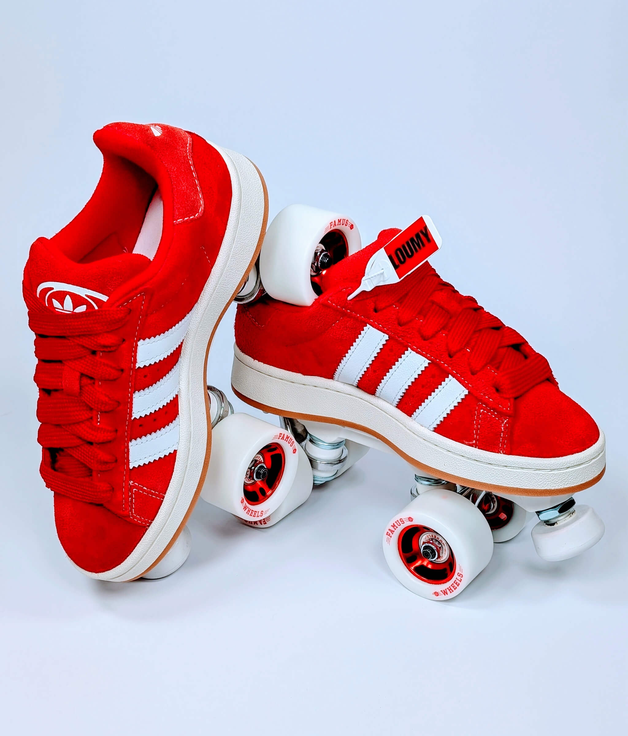 Adidas Campus roller sneakers by Loumy in red, with one tilted and balanced on the other, featuring red wheels with matching metallic rims