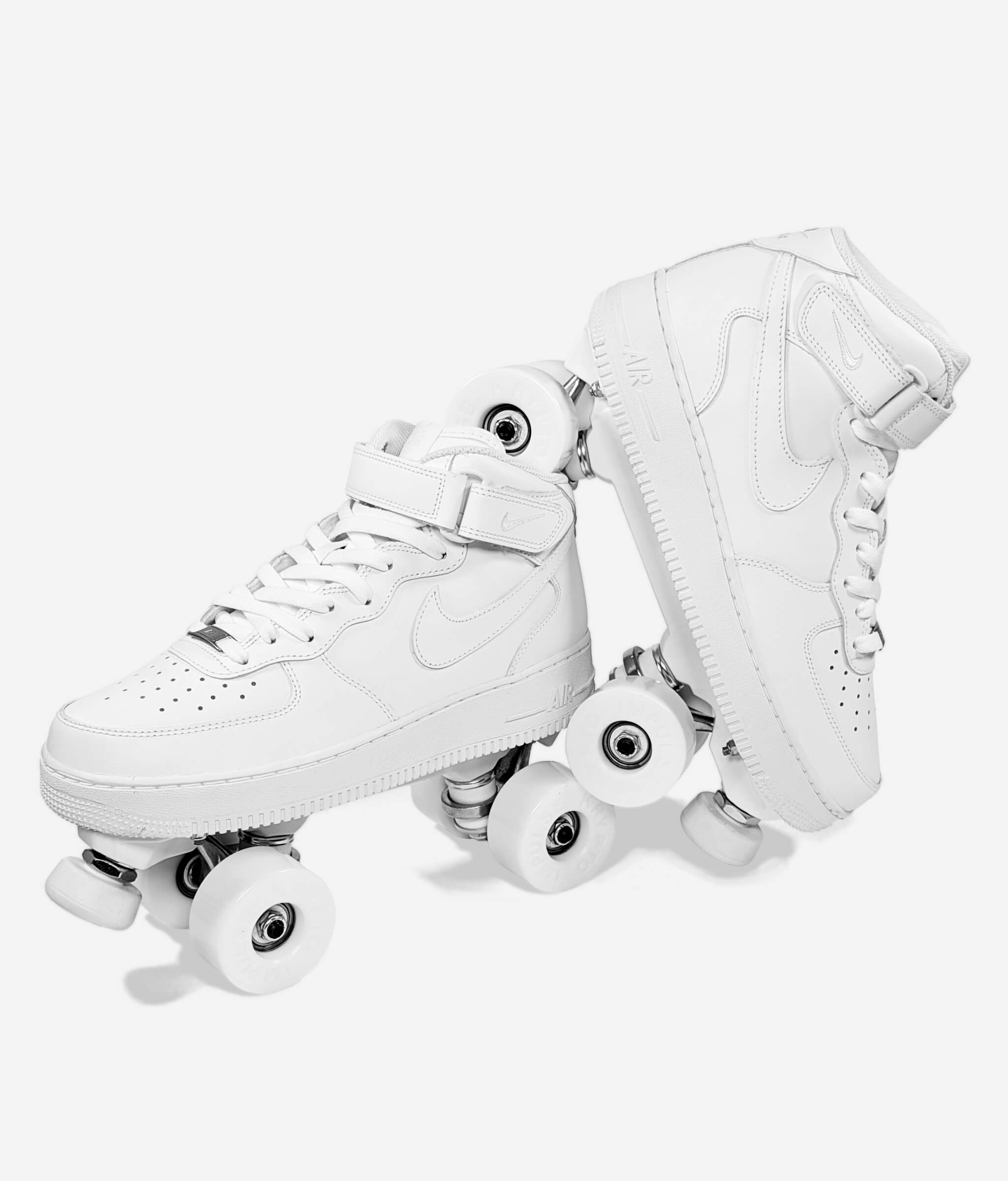 Loumy's roller skate sneakers made from white Nike Air Force 1 Mid, with one tilted and balanced on the other