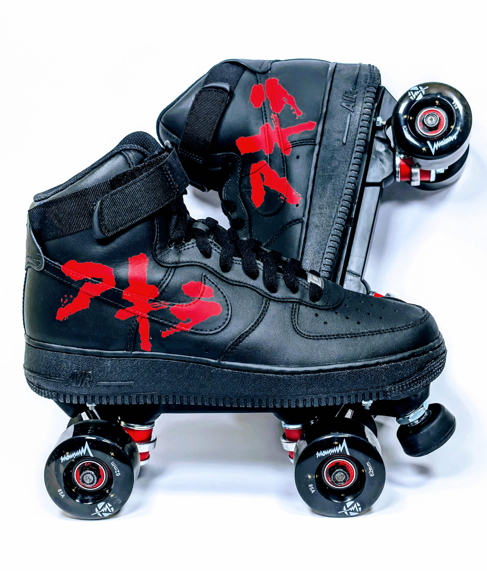 Loumy x Kazy custom roller sneakers made from black Nike Air Force 1 High, with one tilted behind the other, featuring Akira red lettering