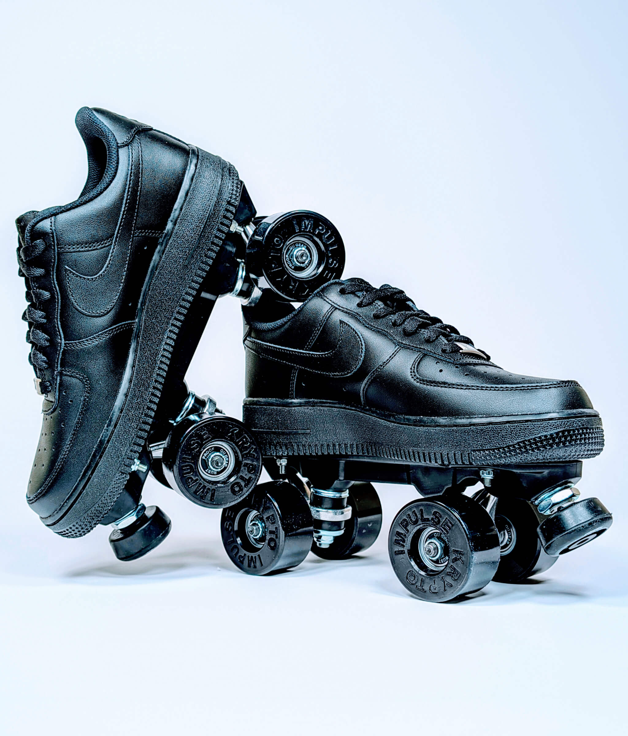 Loumy roller sneakers made from all black Nike Air Force 1 Low, with one tilted and balanced on the other