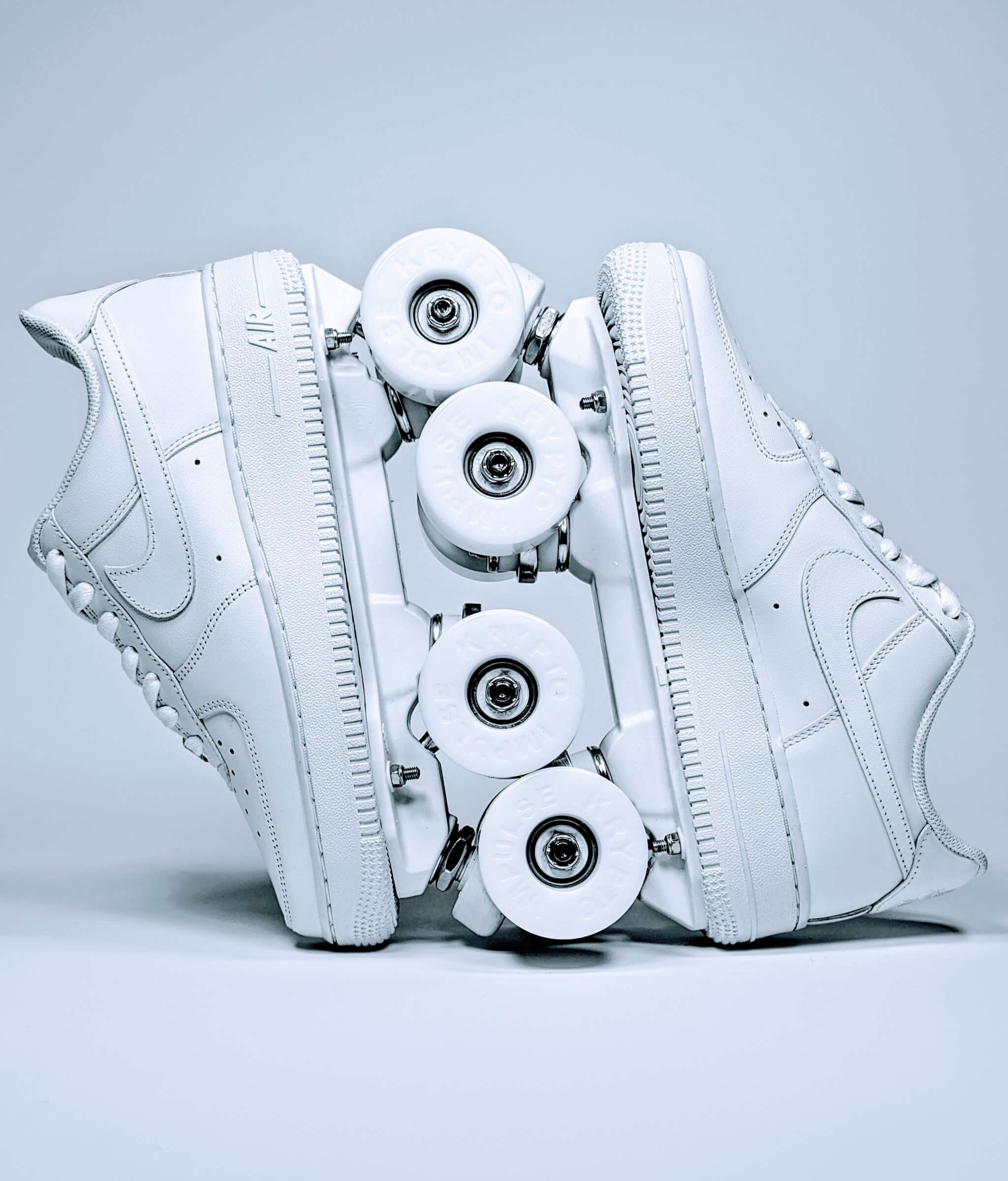 Loumy's Nike Air Force 1 Low roller sneakers in all white, displayed vertically with interlocked wheels