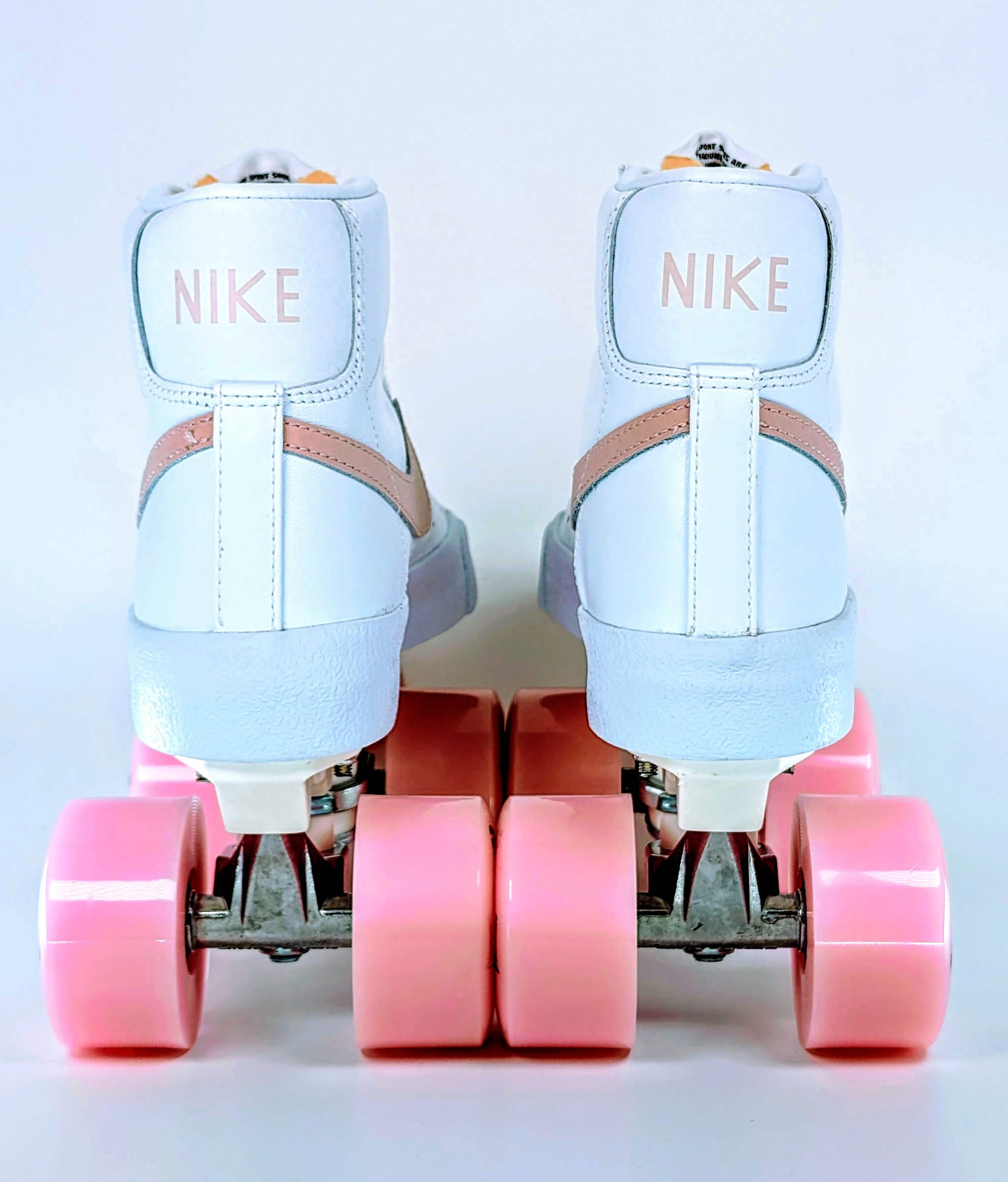 Back view of Loumy's Loumynous Blazer roller sneakers made from white Nike Blazer Mid ’77 with pink LED wheels