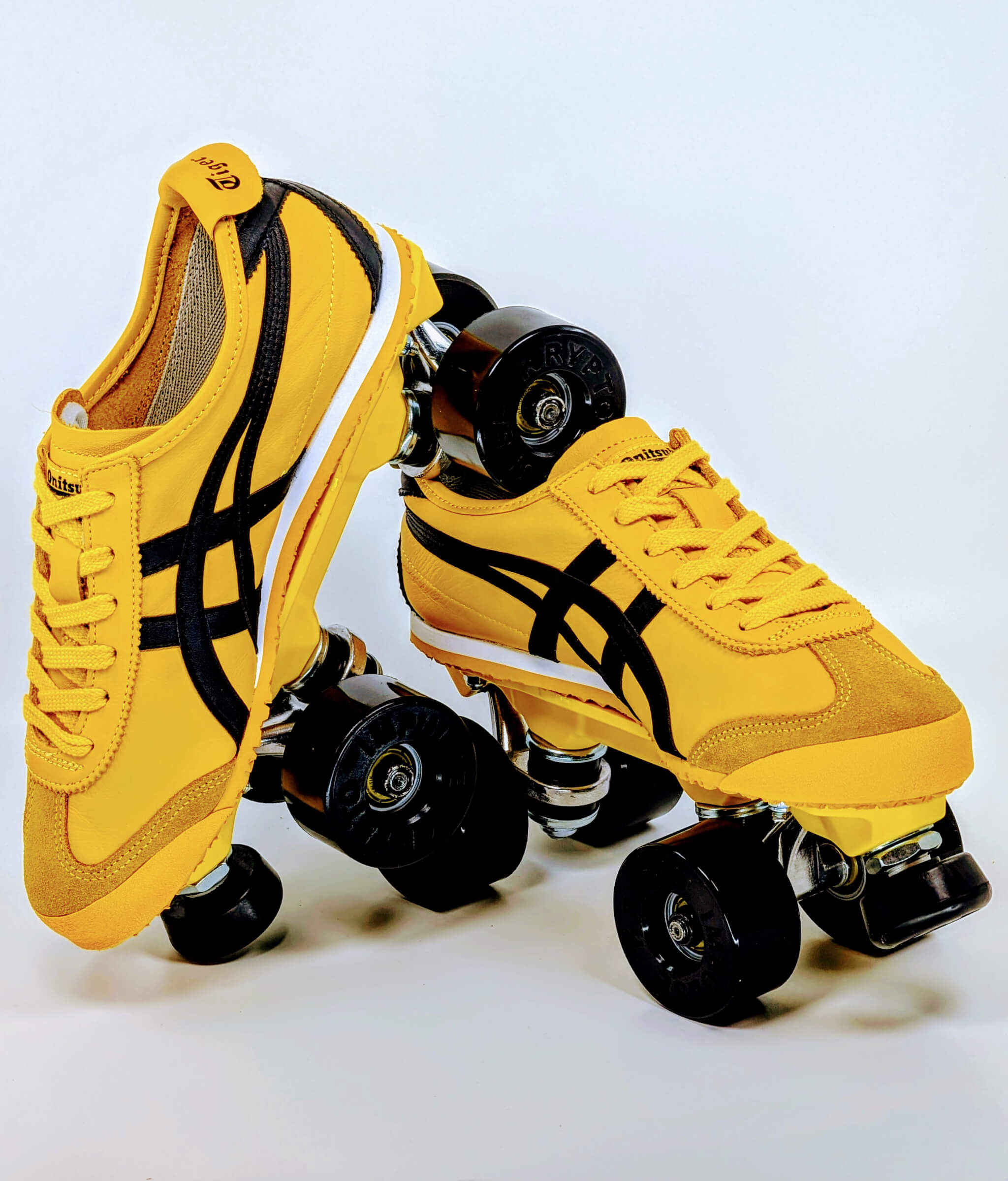 Onitsuka Kill Bill roller sneakers by Loumy in yellow and black, with one roller sneaker tilted and balanced on the other, featuring black wheels