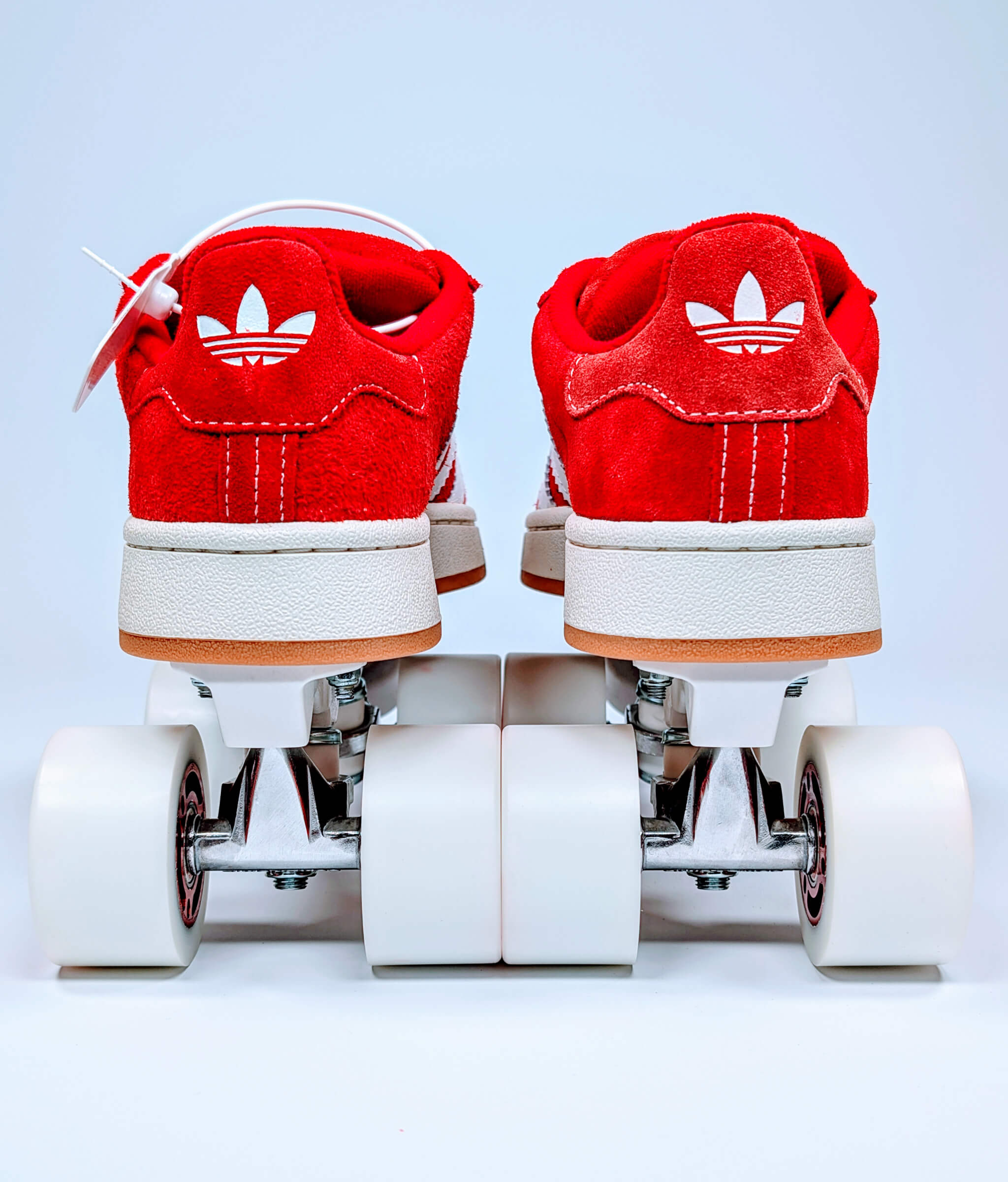 Back view of Loumy's red Adidas Campus roller sneakers with red wheels and metallic rims