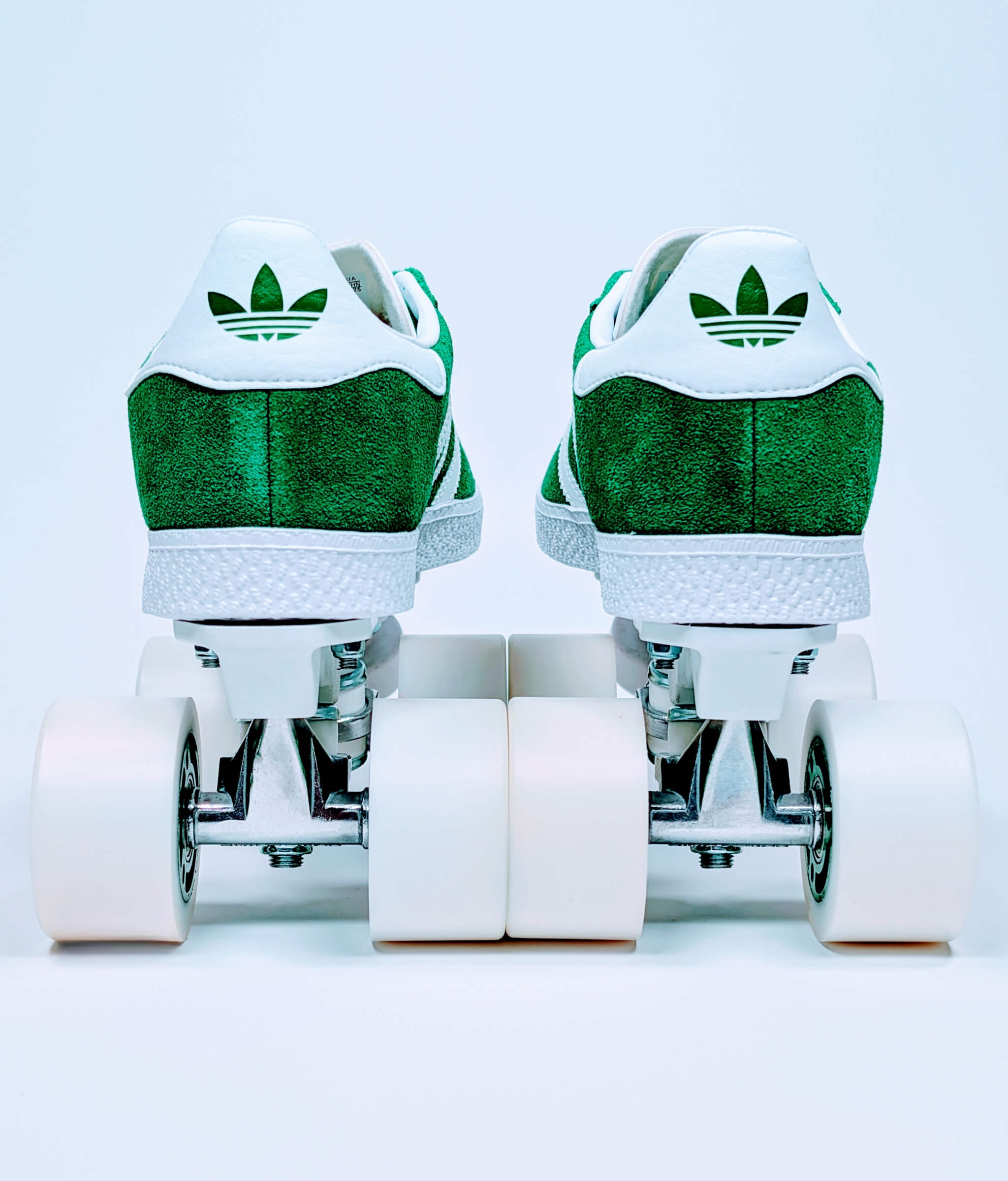 Back view of Loumy's green Adidas Gazelle roller sneakers