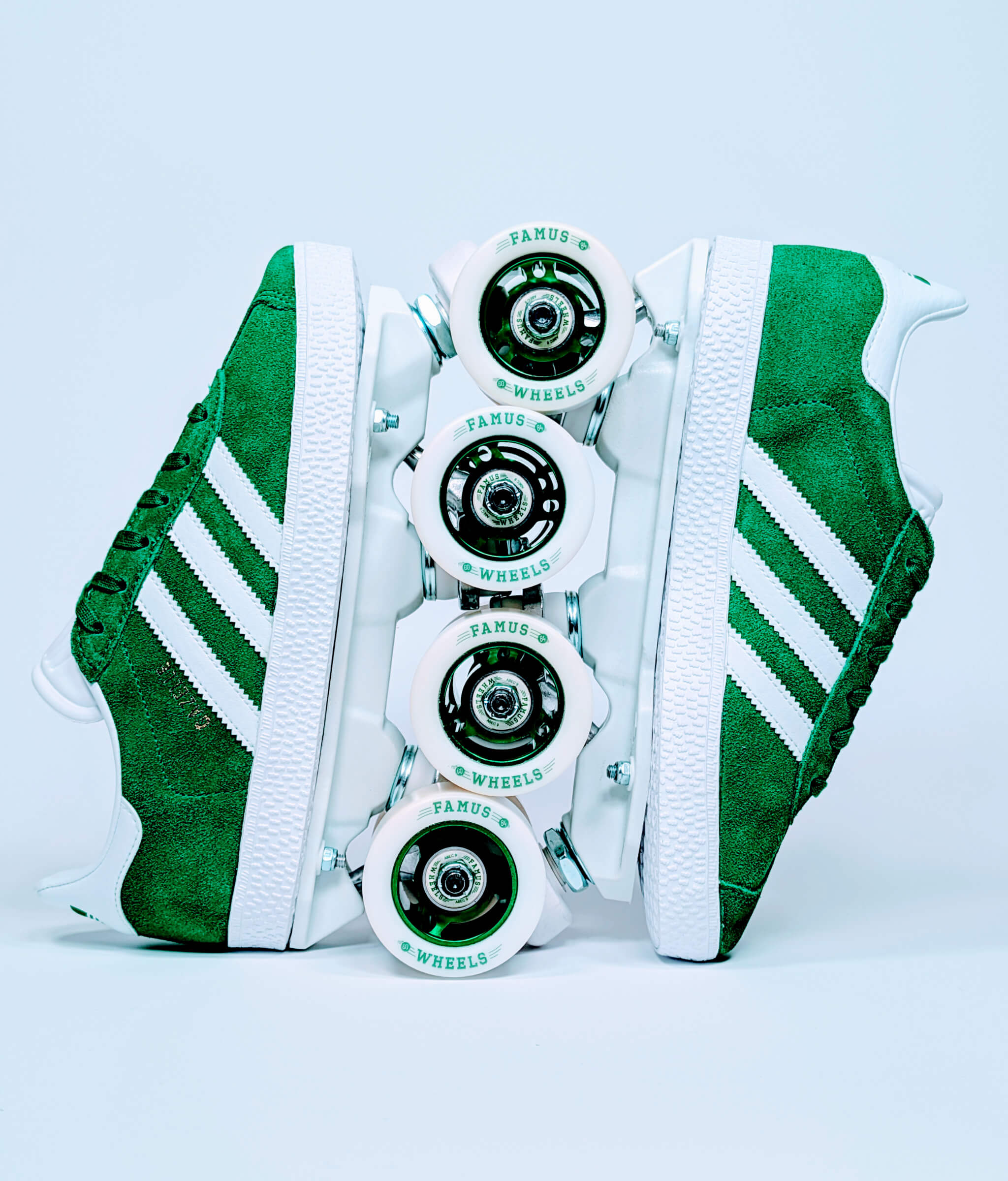 Green Adidas Gazelle roller sneakers by Loumy, displayed vertically with interlocked wheels and metallic green rims