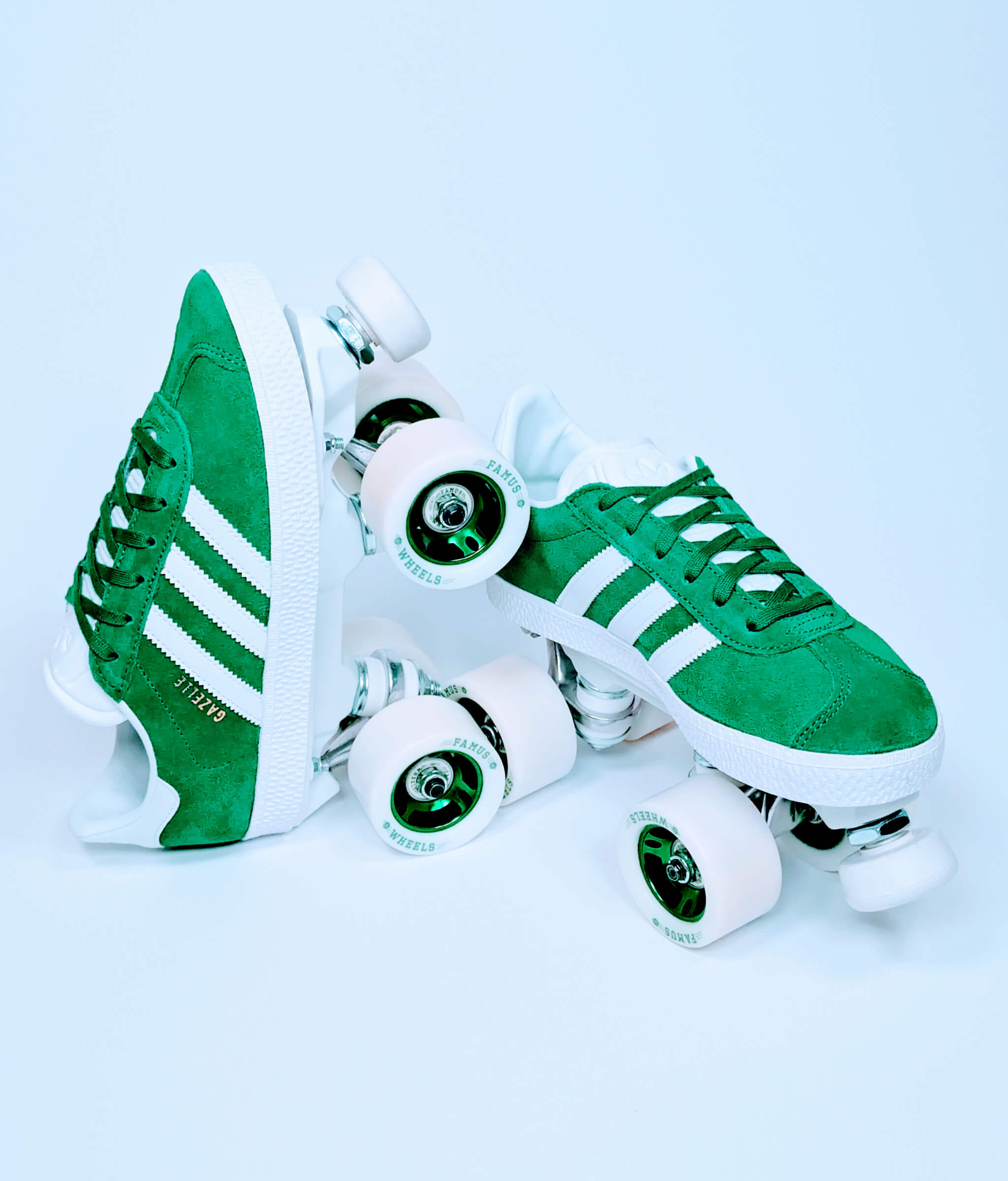 Adidas Gazelle roller sneakers by Loumy in green, with one tilted roller sneaker balanced on the other, featuring wheels with green metallic rims