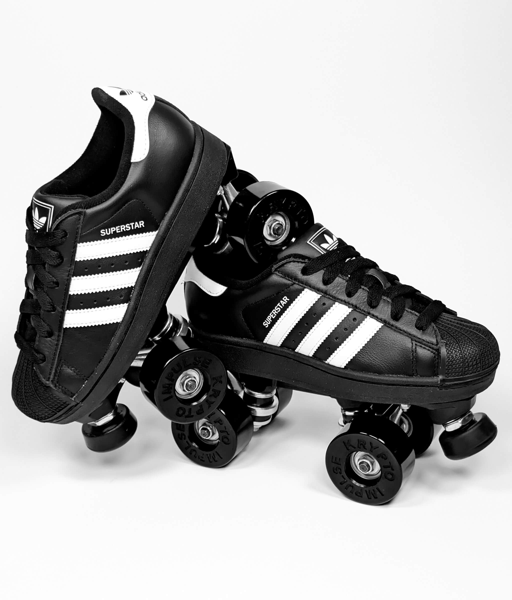 Loumy’s Adidas Superstar roller sneakers in black and white in a tilted view