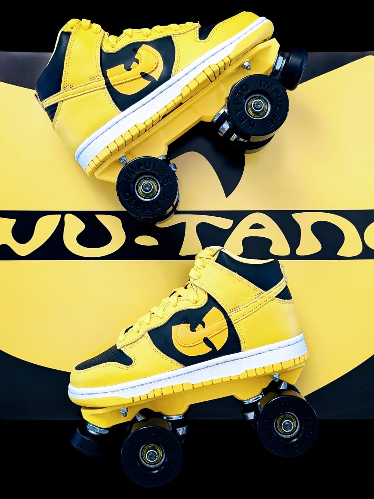 Two Nike Dunk High Iowa roller skate sneakers by Loumy’s World shown in full over a large yellow-and-black Wu-Tang Clan emblem, with logos hand-painted by Kazy