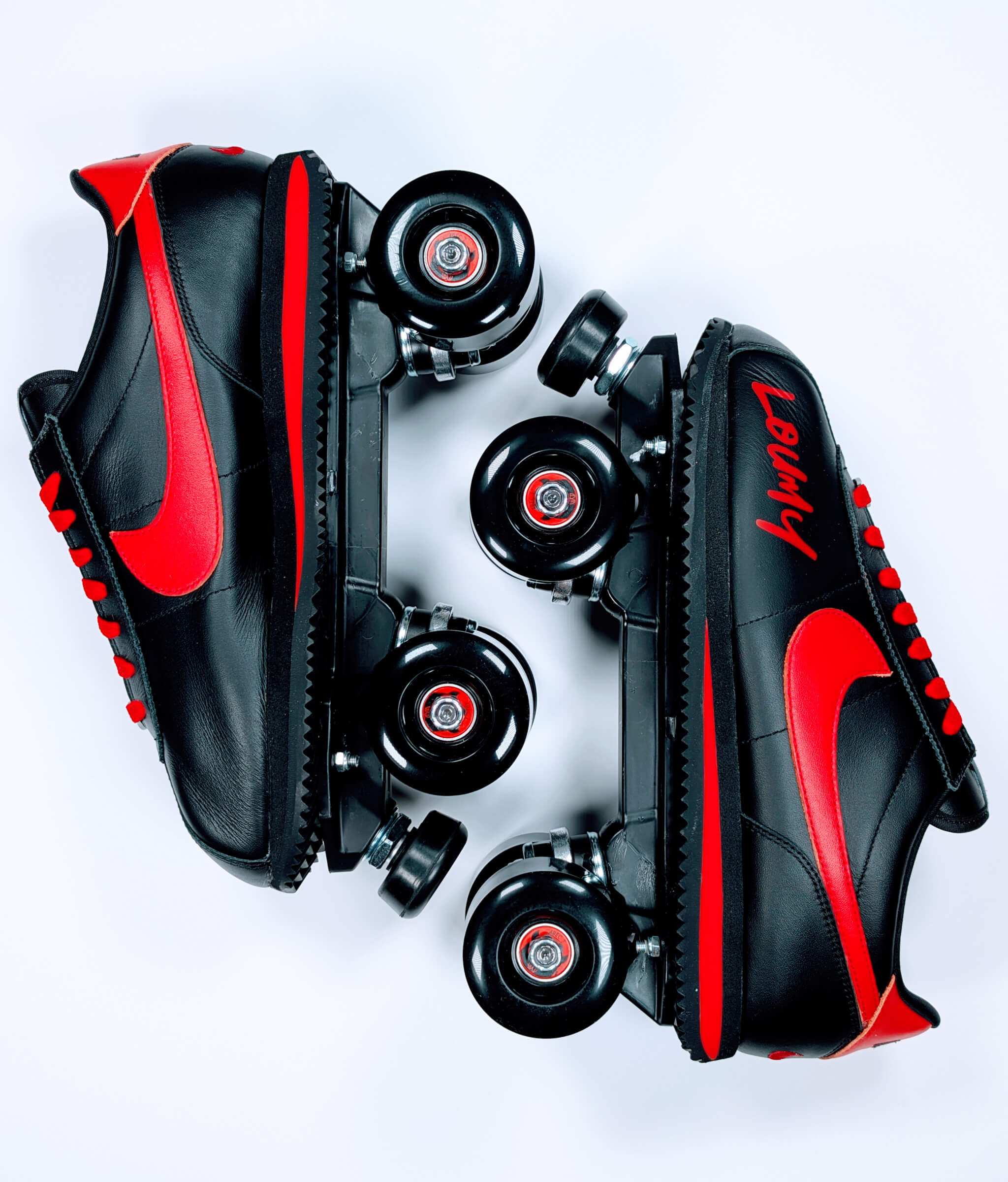 Custom Nike Cortez roller sneakers by Loumy x Kazy in mirrored position, featuring black leather, vivid red details, and graffiti-style Loumy tag