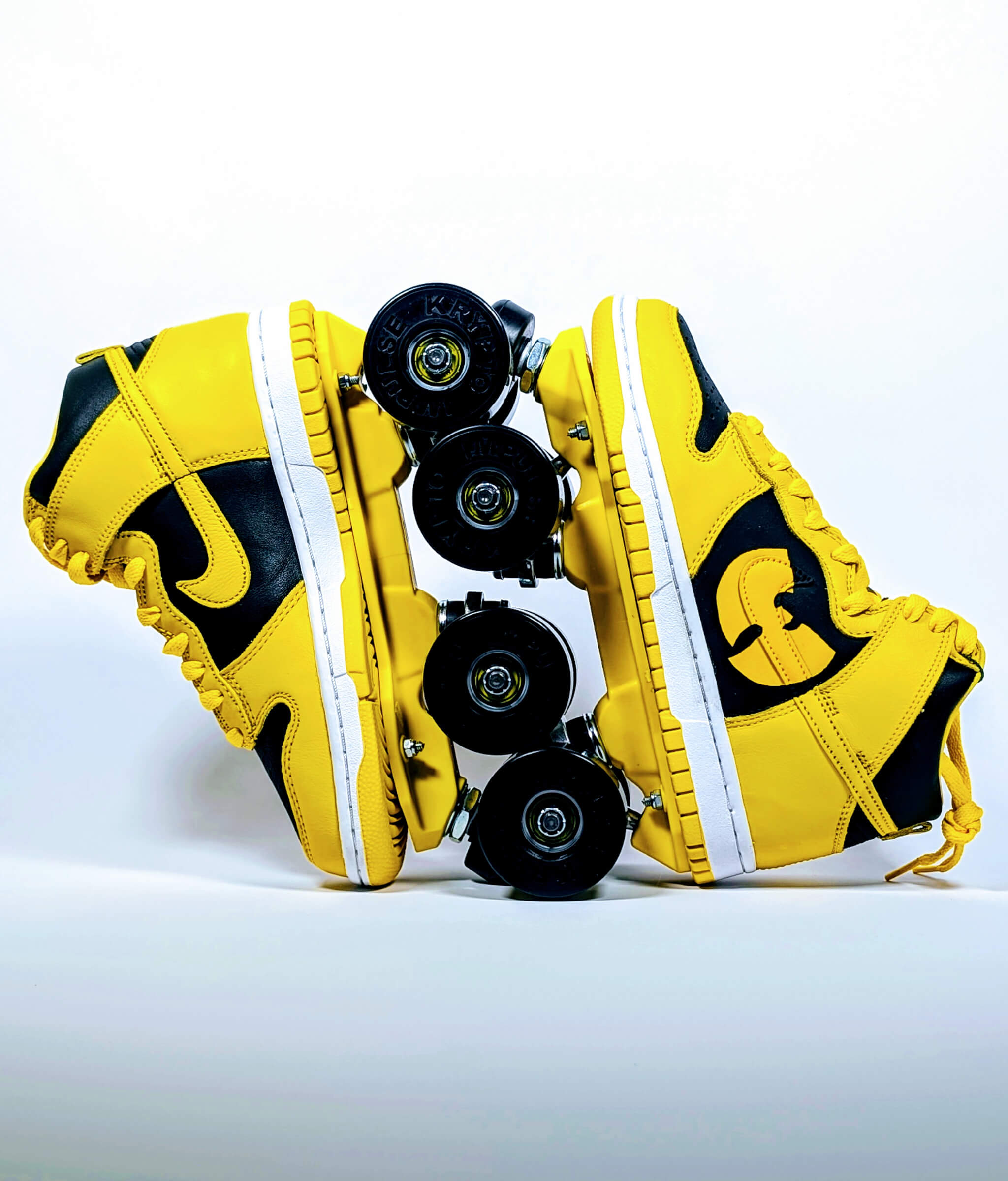 Loumy x Kazy Nike Dunk Iowa roller sneakers in black and yellow, displayed vertically with interlocked wheels and Wu-Tang Clan custom emblem
