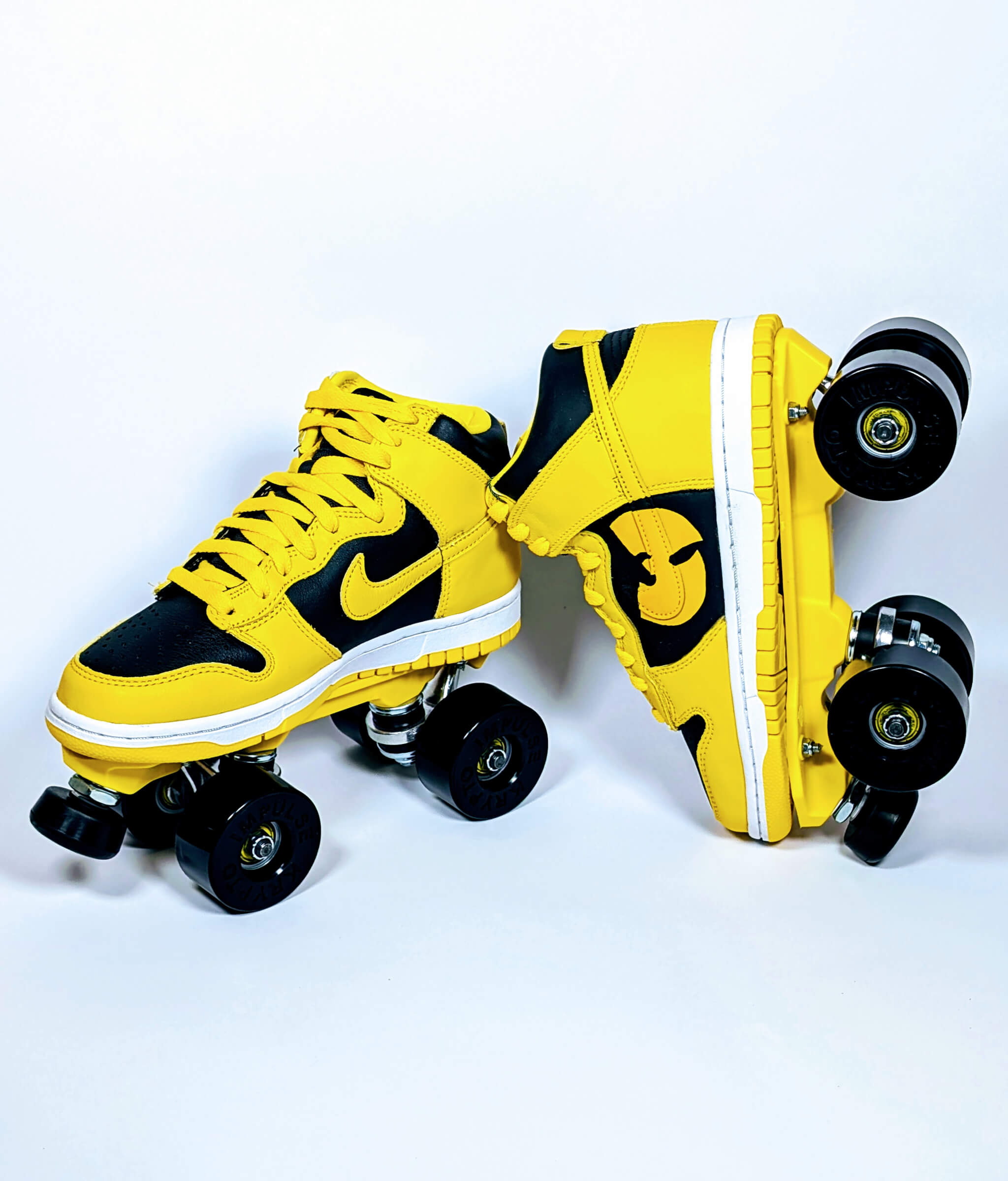 Loumy x Kazy custom roller sneakers made from black and yellow Nike Dunk Iowa, with one tilted and balanced on the other, featuring Wu-Tang Clan details
