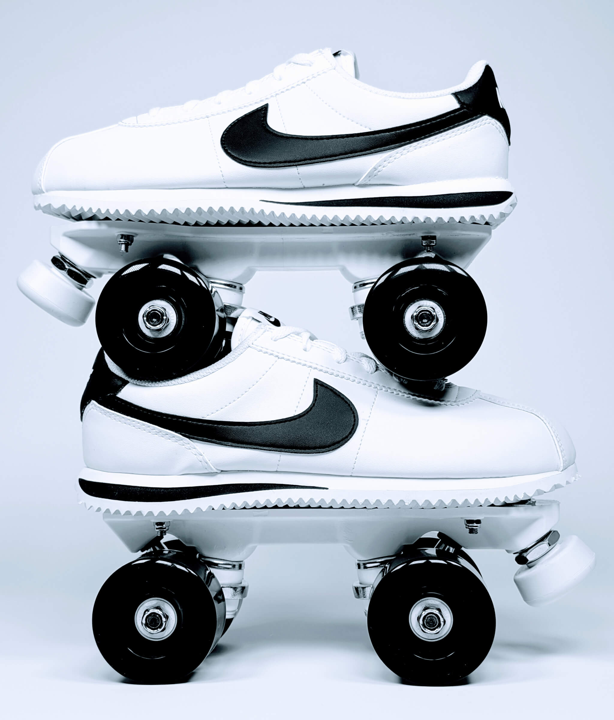 Nike Cortez roller sneakers by Loumy, stacked side view in black and white