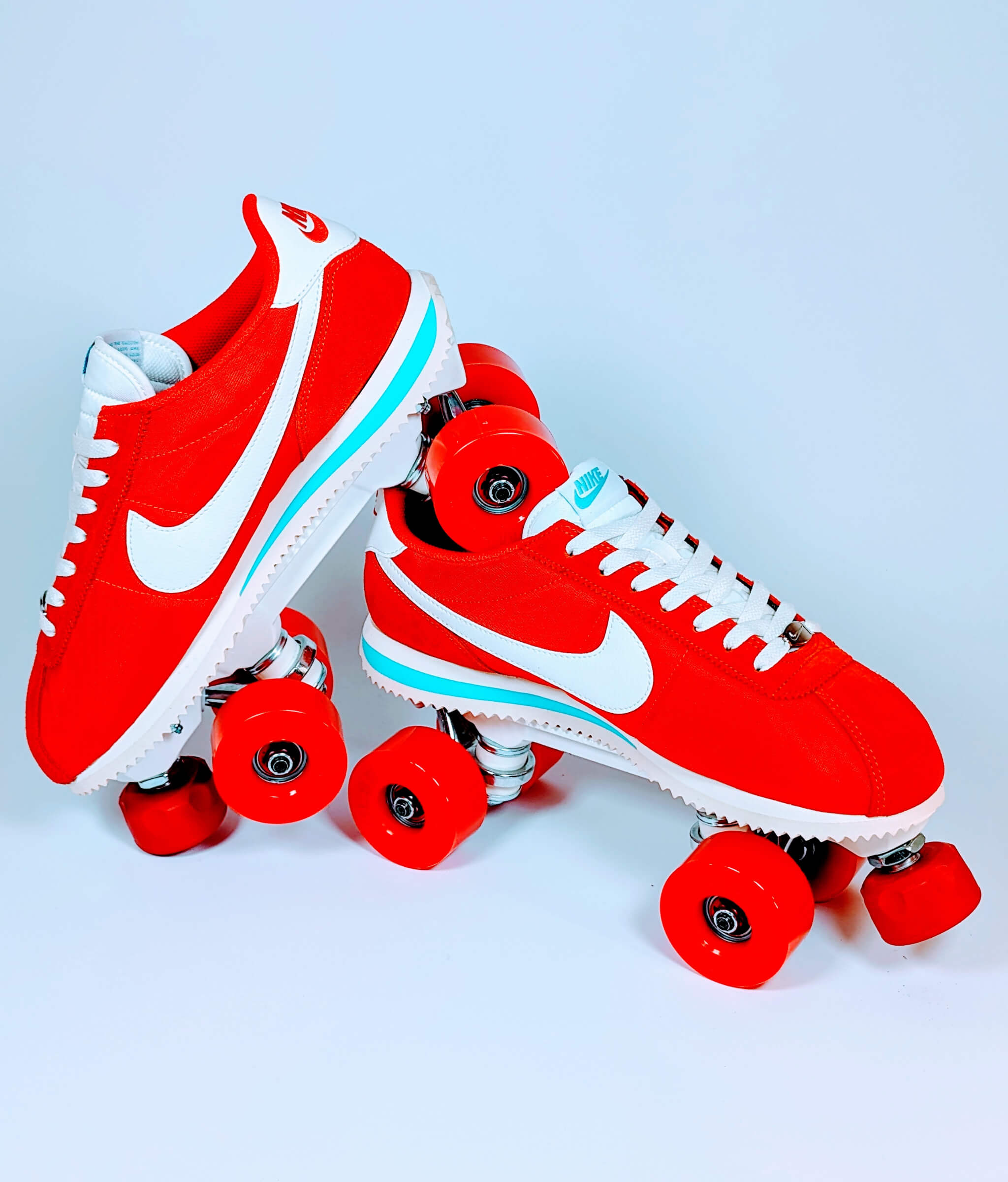 Red and white Nike Cortez roller sneakers by Loumy, with one tilted balanced on the other