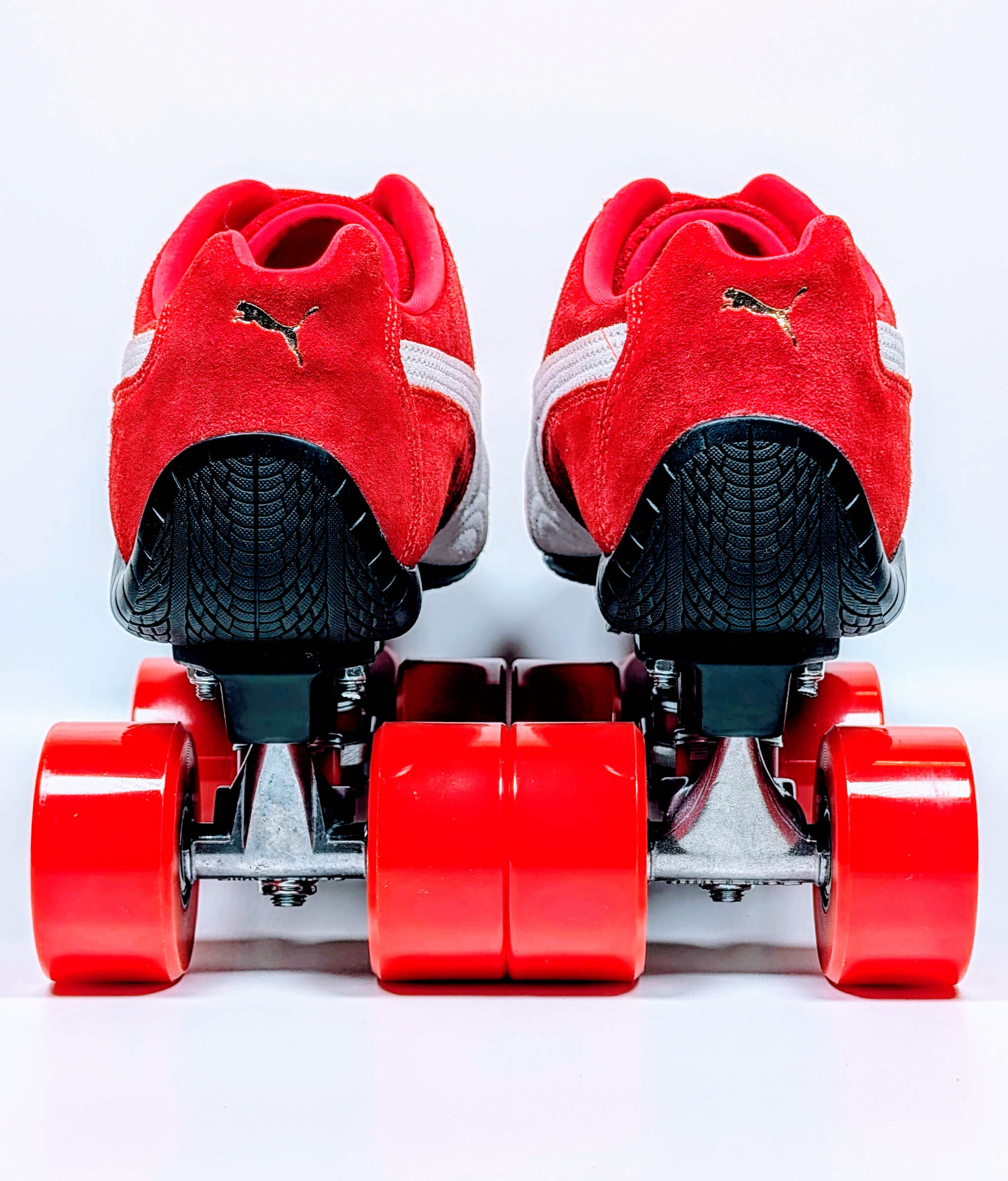 Back view of Loumy's red and black Speedcat OG roller sneakers with premium components