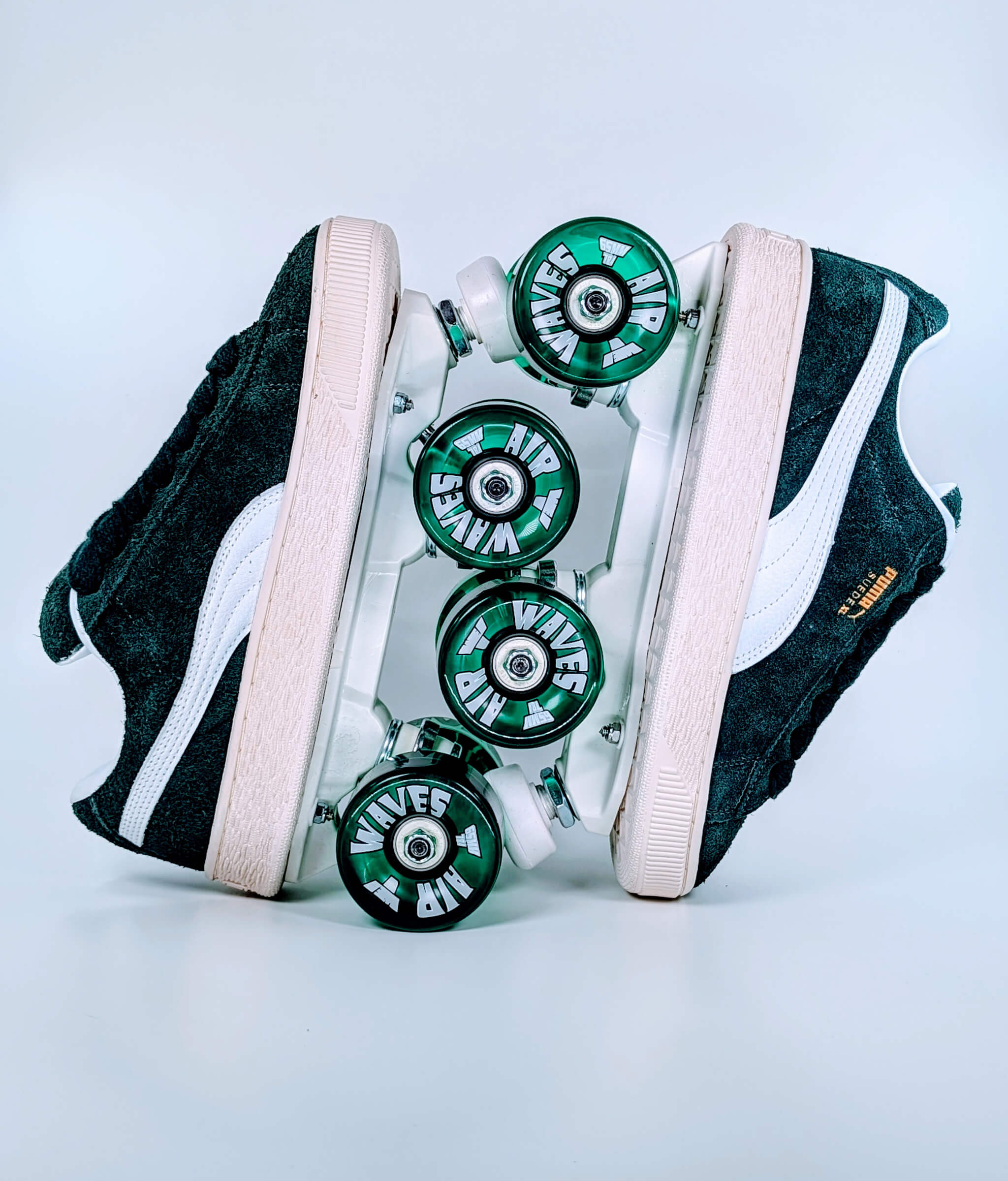 Puma XL Hairy Suede roller sneakers by Loumy in dark green, displayed vertically with interlocked wheels in translucent green