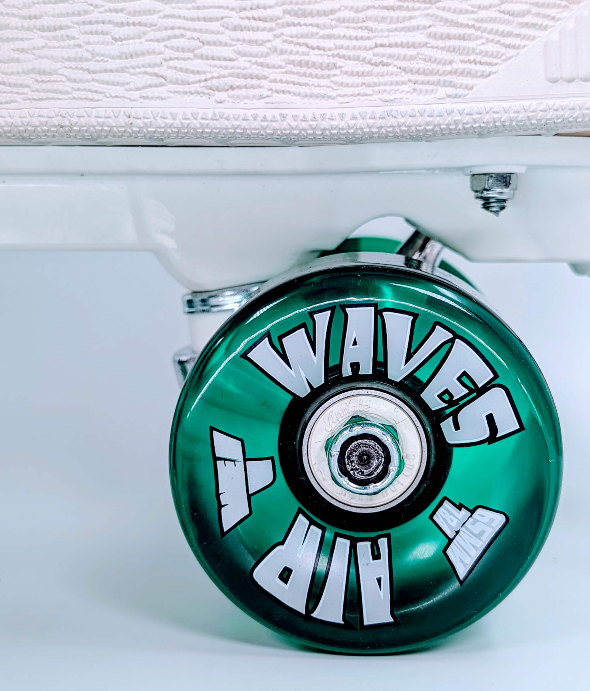 Close-up of translucent green wheel on Loumy's Puma XL Hairy Suede roller sneakers, showing white bearings inside