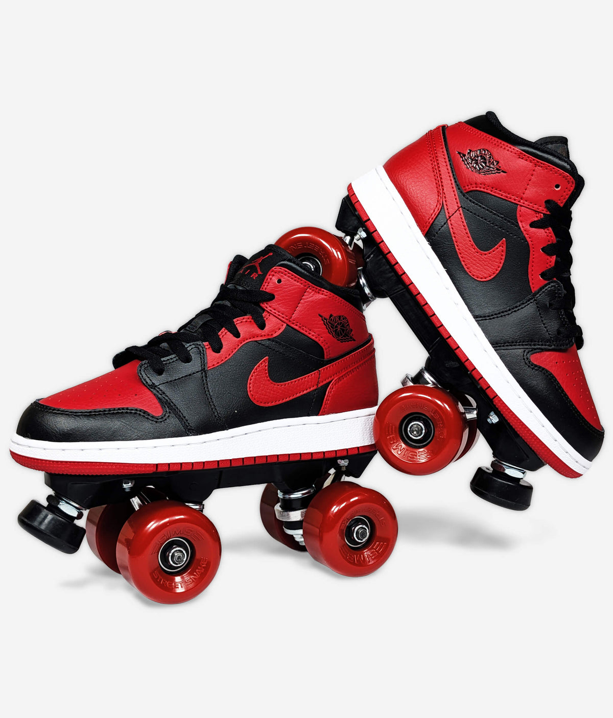 Nike Air Jordan Banned 2020 roller skate sneakers by Loumy’s World with red wheels, one leaning against the other.
